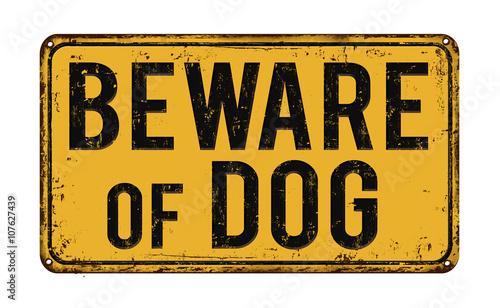 Beware of dog on yellow vintage rusty retro sign